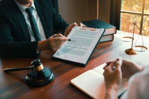 lawyer advising clients reviewing paperwork for legal proceedings and legal advice